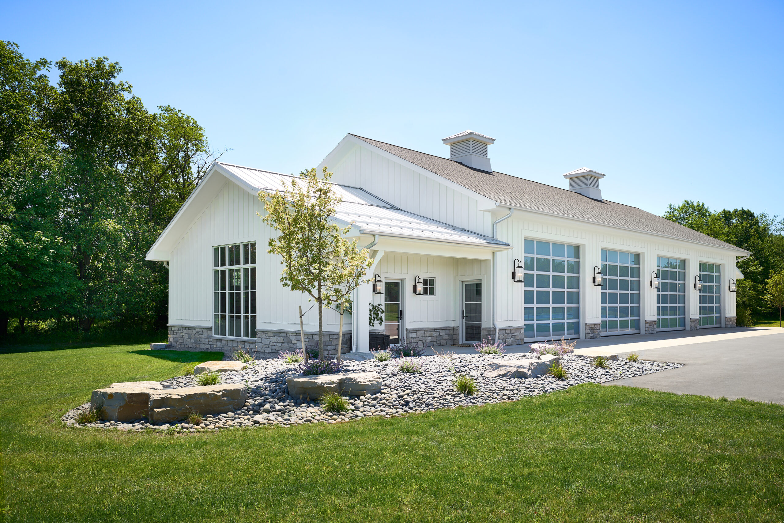 barn-modern-white-event-barn-exterior-design Custom kitchen design with navy cabinetry and marble backsplash